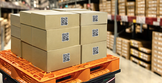 Boxes inside a warehouse with QR codes for easier inventory management.