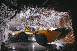 Mining truck in underground tunnel extracting silver.