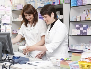 Two Friendly Pharmacists Working Together in the Drugstore.