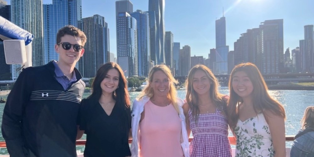 Minitab Interns standing in front of the Chicago River and Chicago skyline