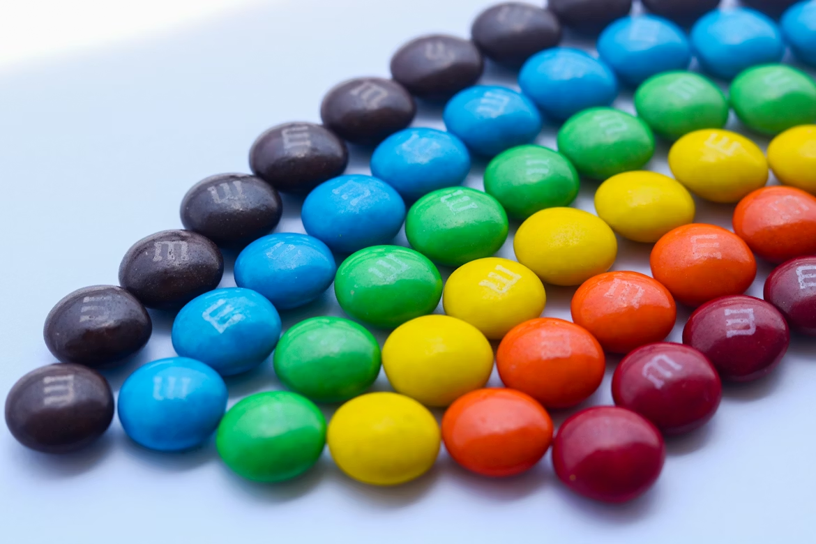 A row of colorful candy m&m's sitting on top of a table
