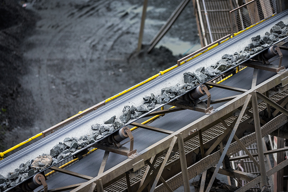 Conveyor belt transferring metals and stones out of a mine with an improved technique.