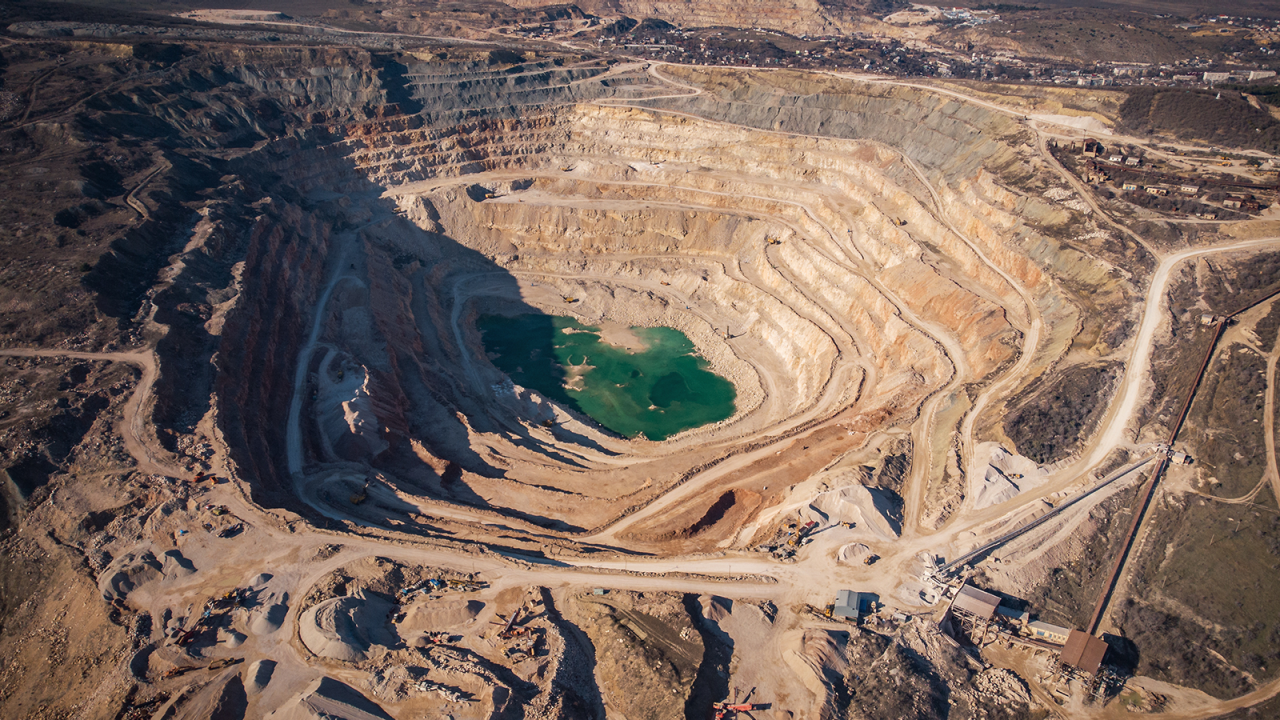 Aerial view of open cast quarry for digging and production of flux limestone, gravel material, crushed stone, and sand.