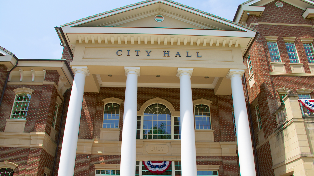 Front of brick city hall building.