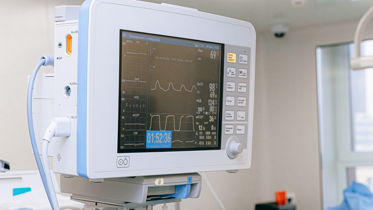 Heart beat monitor in a doctor's office displaying vital signs.