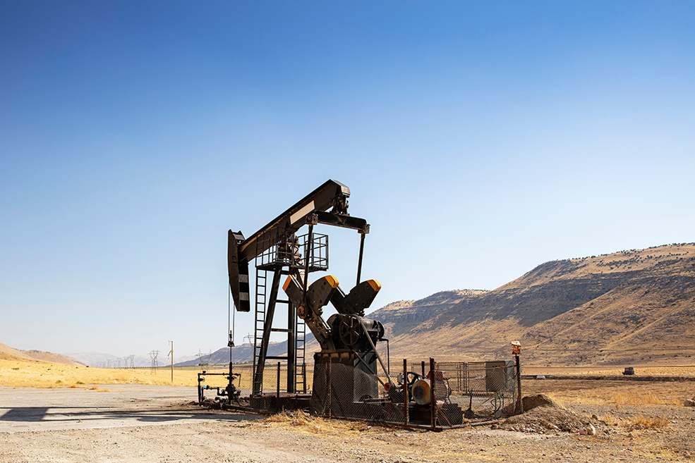 Oil drilling derricks at desert oilfield.